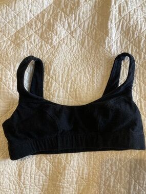 Two black sports bras by Knickey